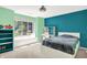 Bright bedroom with teal and green walls, a large window, and modern furniture at 5953 Deer Hollow Ct, Pittsboro, IN 46167