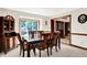 Elegant dining room featuring a large window, wooden table with seating for six, and classic furnishings at 5953 Deer Hollow Ct, Pittsboro, IN 46167