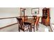 Stylish dining room with a dark wood table, seating for six, and a built-in cabinet for storage and display at 5953 Deer Hollow Ct, Pittsboro, IN 46167
