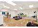 Well-lit exercise room featuring hardwood floors, mirrors, and exercise equipment at 5953 Deer Hollow Ct, Pittsboro, IN 46167