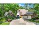 Charming red brick home with a three-car garage and mature trees, providing shade and curb appeal at 5953 Deer Hollow Ct, Pittsboro, IN 46167