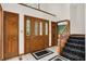 Inviting foyer with tile flooring, a staircase, and a wood door with glass panels, creating an open and welcoming entrance at 5953 Deer Hollow Ct, Pittsboro, IN 46167