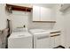 A spacious laundry room equipped with a washer, dryer, storage cabinets, and countertop space at 5953 Deer Hollow Ct, Pittsboro, IN 46167