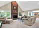 Spacious living room with a vaulted ceiling, brick fireplace, and comfortable seating, perfect for relaxation and gatherings at 5953 Deer Hollow Ct, Pittsboro, IN 46167
