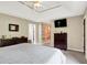Bedroom features ceiling fan, dresser, and a large bed with access to ensuite bathroom at 5953 Deer Hollow Ct, Pittsboro, IN 46167