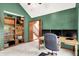 Functional office featuring a built-in bookshelf and multiple monitors, providing ample space for storage and productivity at 5953 Deer Hollow Ct, Pittsboro, IN 46167