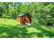 View of outbuilding on a grassy lot surrounded by shady trees at 5953 Deer Hollow Ct, Pittsboro, IN 46167