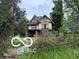 Two story home with Tudor architecture needing full renovation, surrounded by mature trees at 609 E 37Th St, Indianapolis, IN 46205