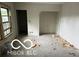 Spacious living room with a window and some construction debris on the floor at 609 E 37Th St, Indianapolis, IN 46205