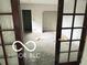 An open living space is seen through a set of French doors at 609 E 37Th St, Indianapolis, IN 46205