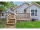 Backyard showcasing a wooden deck, grey siding, and well-maintained lawn at 617 N Dearborn St, Indianapolis, IN 46201