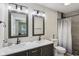 Modern bathroom with dual sinks, large mirrors, updated fixtures, and a shower at 617 N Dearborn St, Indianapolis, IN 46201