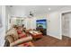 Inviting living room boasts hardwood floors, a ceiling fan, and a large television for ultimate comfort at 617 N Dearborn St, Indianapolis, IN 46201