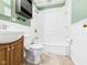 Bathroom with a sink, toilet, and a shower-tub combo at 619 Belzer Dr, Anderson, IN 46011
