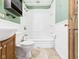 Bathroom with a sink, toilet, and a shower-tub combo at 619 Belzer Dr, Anderson, IN 46011