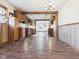 Open-concept dining room featuring hardwood floors and seamless transition to the kitchen and living room at 619 Belzer Dr, Anderson, IN 46011