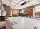 View of spacious garage with wood paneling and bright overhead lighting at 619 Belzer Dr, Anderson, IN 46011
