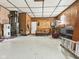 View of spacious garage with wood paneling and concrete flooring at 619 Belzer Dr, Anderson, IN 46011
