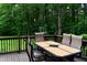 Backyard deck with outdoor dining furniture for six people overlooking a lush forest at 6190 Red Day Rd, Martinsville, IN 46151