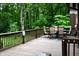 View of backyard deck with dining table and chairs set for six people, facing a lush green forest at 6190 Red Day Rd, Martinsville, IN 46151