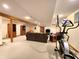 Spacious basement featuring carpeting, exposed wood beams, a sofa, bookshelves, and an elliptical machine at 6190 Red Day Rd, Martinsville, IN 46151