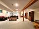 Spacious finished basement with a sofa, elliptical, bookshelves, and a chess set on a coffee table at 6190 Red Day Rd, Martinsville, IN 46151