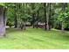 Secluded brick home exterior nestled among mature trees and lush green lawn at 6190 Red Day Rd, Martinsville, IN 46151