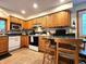 Bright kitchen with oak cabinetry, tile flooring, and modern appliances at 6190 Red Day Rd, Martinsville, IN 46151