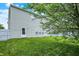 Backyard with lush green grass and the rear of a two story home at 630 Harmony Way, Greenwood, IN 46143