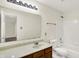 Bathroom features a spacious countertop and mirror and a tub with shower at 630 Harmony Way, Greenwood, IN 46143