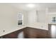 Cozy bedroom featuring hardwood floors, a bright window, and neutral wall color at 630 Harmony Way, Greenwood, IN 46143