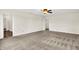 Large bedroom with carpet flooring, neutral walls, a ceiling fan, and a doorway to another room at 630 Harmony Way, Greenwood, IN 46143