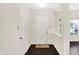 Bright foyer with hardwood floors, white walls, and a cheerful welcome mat at 630 Harmony Way, Greenwood, IN 46143