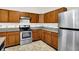 Functional kitchen with wood cabinets, stainless steel appliances, and stylish countertops for culinary enjoyment at 630 Harmony Way, Greenwood, IN 46143