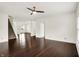 Open-concept living room featuring hardwood floors, staircase access, and abundant natural light at 630 Harmony Way, Greenwood, IN 46143