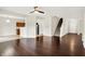 Inviting living area showcasing hardwood floors, staircase, open layout, and seamless transition to the kitchen at 630 Harmony Way, Greenwood, IN 46143
