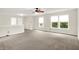 Spacious living room with carpet flooring, neutral walls, bright windows, and a ceiling fan at 630 Harmony Way, Greenwood, IN 46143