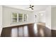Bright living room with hardwood floors, ceiling fan, and large windows offering ample natural light at 630 Harmony Way, Greenwood, IN 46143