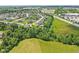 Aerial view showcasing a residential community with lush greenery and surrounding landscapes at 644 Ridge Gate Dr, Brownsburg, IN 46112