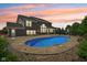 Beautiful backyard pool with water feature, complemented by an outdoor patio and well-maintained landscaping at 644 Ridge Gate Dr, Brownsburg, IN 46112