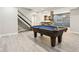 Finished basement space with a pool table, a decorative wooden column, and a bar area with wood accents at 644 Ridge Gate Dr, Brownsburg, IN 46112