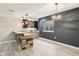 Finished basement featuring a modern bar, luxury vinyl plank flooring, and a dark blue accent wall at 644 Ridge Gate Dr, Brownsburg, IN 46112