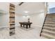 Finished basement with a pool table, a decorative wood column, and carpeted stairs leading to the upper level at 644 Ridge Gate Dr, Brownsburg, IN 46112