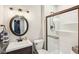 Bathroom with a dark wood vanity, round mirror, a toilet, and a glass enclosed shower with bronze trim at 644 Ridge Gate Dr, Brownsburg, IN 46112