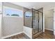Modern bathroom with a tiled shower, a window and stylish patterned walls at 644 Ridge Gate Dr, Brownsburg, IN 46112