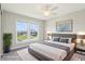 Cozy bedroom with ceiling fan, large windows, and hardwood floors at 644 Ridge Gate Dr, Brownsburg, IN 46112