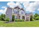 Charming two-story home featuring brick and siding with a well-manicured lawn and blue sky at 644 Ridge Gate Dr, Brownsburg, IN 46112