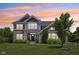 Charming two-story home featuring brick and siding with a well-manicured lawn and colorful sunset at 644 Ridge Gate Dr, Brownsburg, IN 46112
