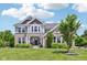 Charming two-story home featuring brick and siding with a well-manicured lawn and blue sky at 644 Ridge Gate Dr, Brownsburg, IN 46112