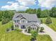 Aerial view of a charming two-story home with a brick facade and landscaped yard at 644 Ridge Gate Dr, Brownsburg, IN 46112